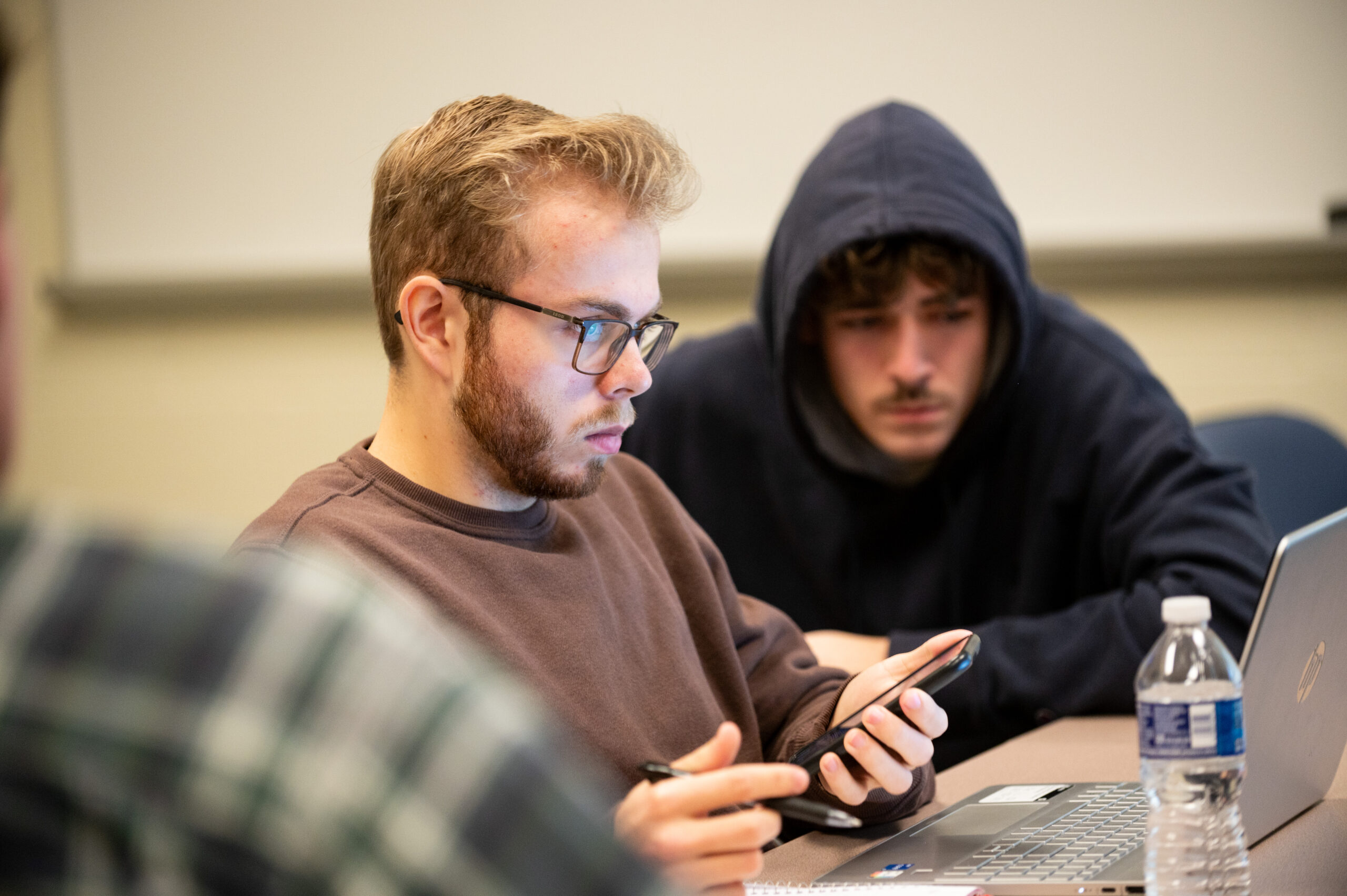 Students working on computers and using calculator