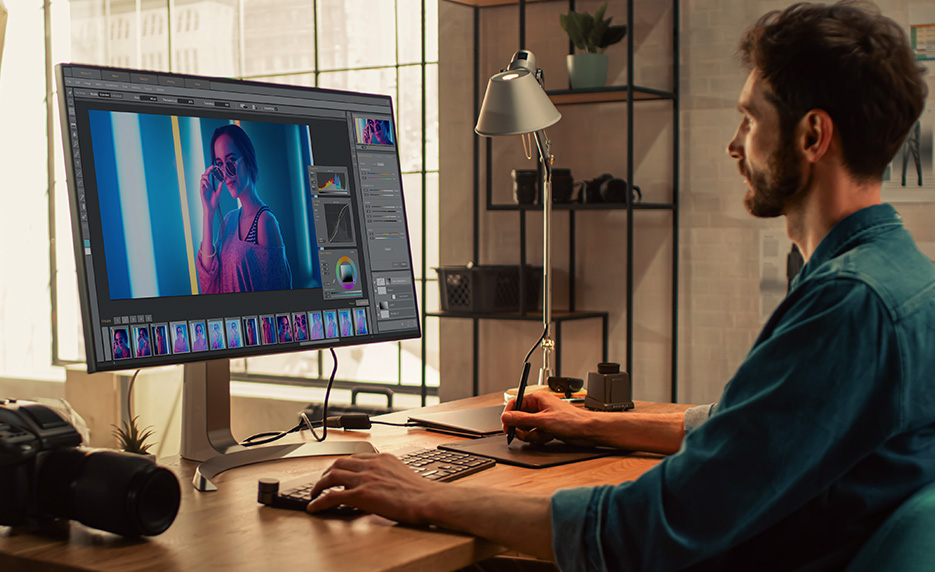 Man completing online assignment on home desktop computer.