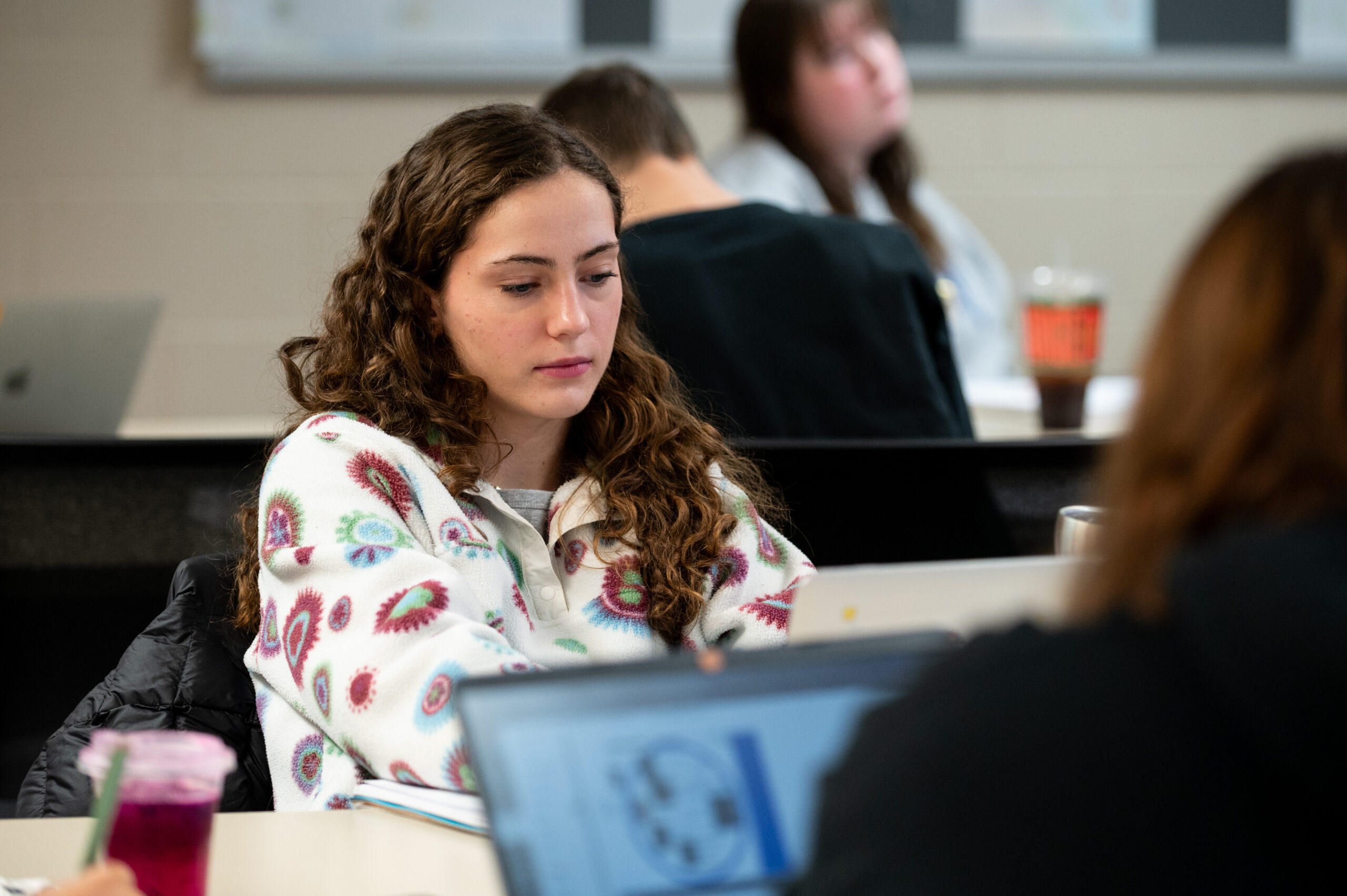 A student in class looks down at her notes