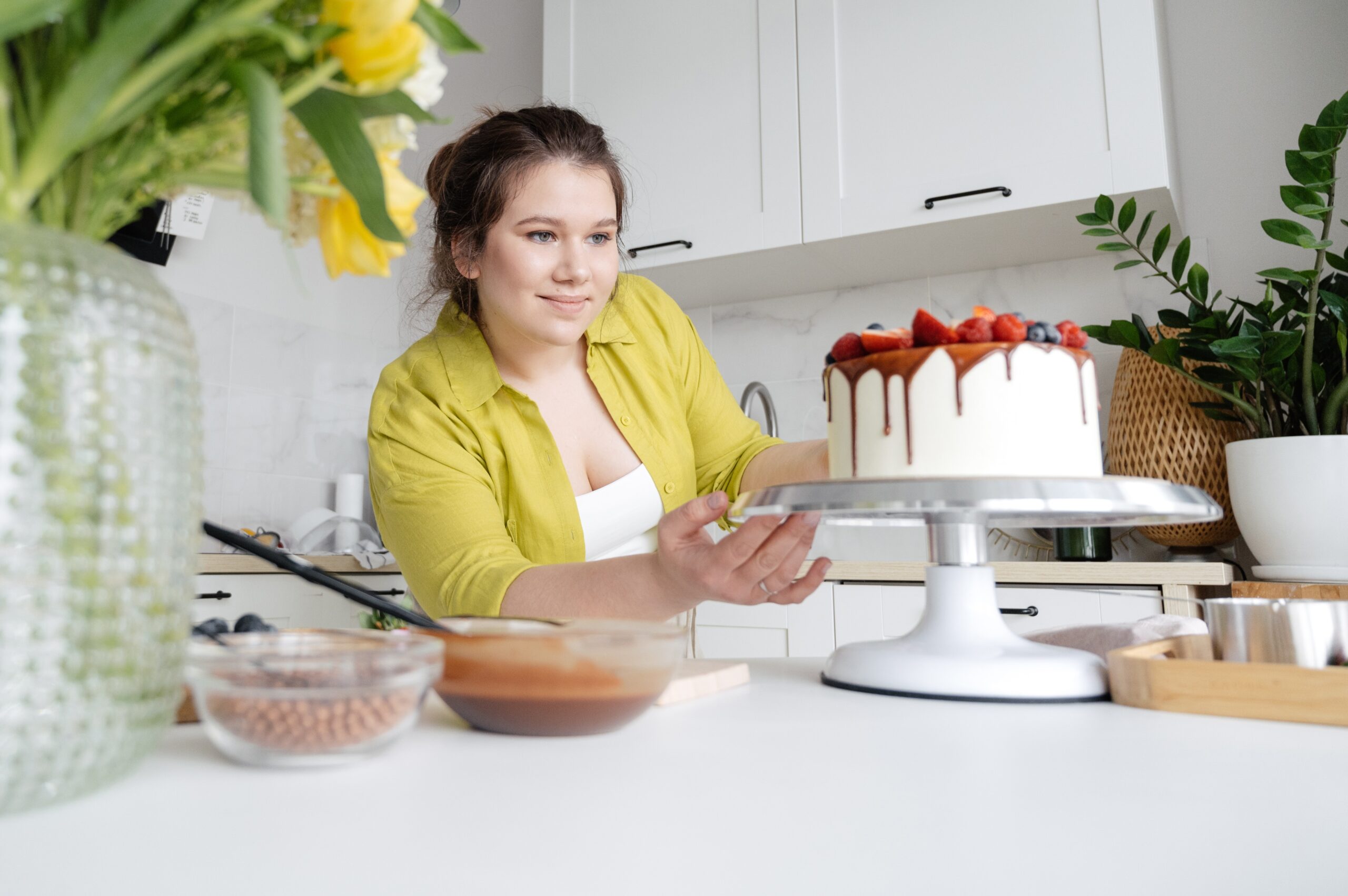 woman decorating a cake