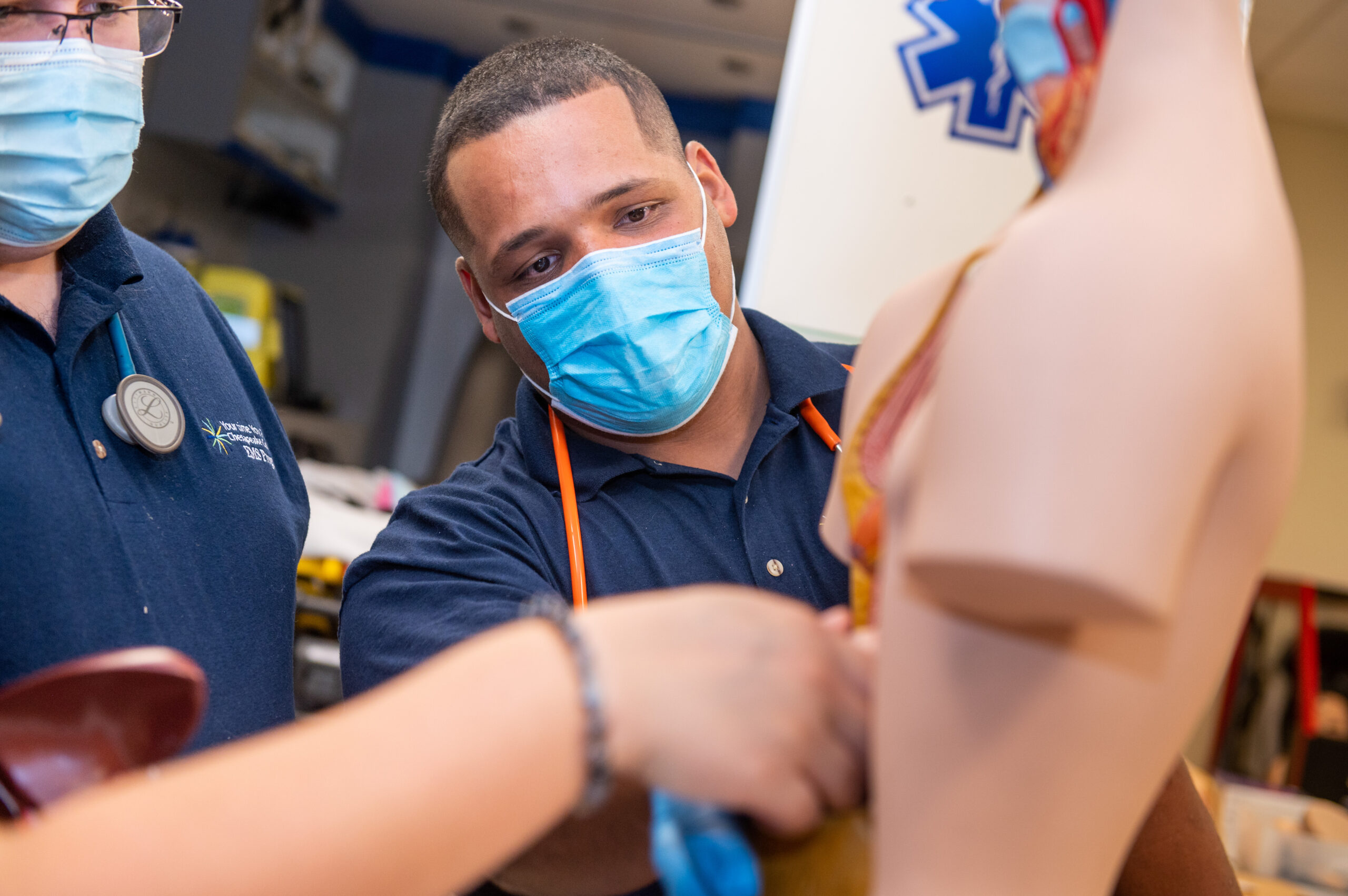 EMS student practicing on medical mannequins.