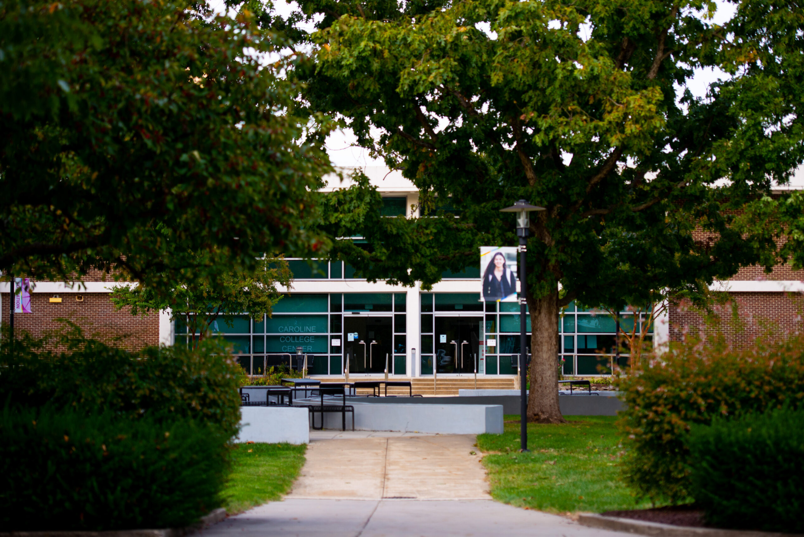 front facade of the Caroline Center as seen through the picnic table area