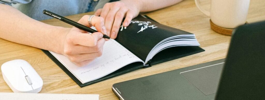 Writing in journal at a desk