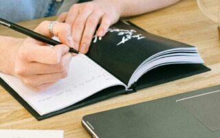 Writing in journal at a desk