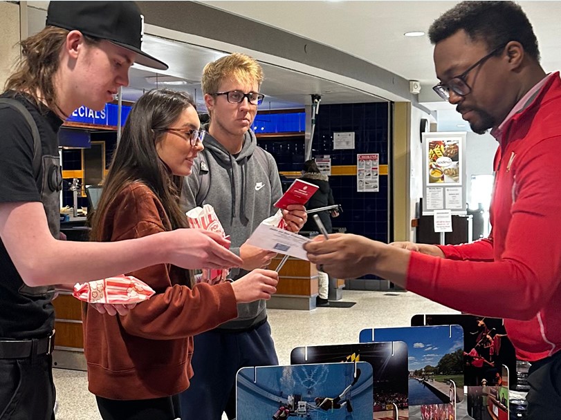 Transfer Day 2023 students receive literature from a University of Maryland representative