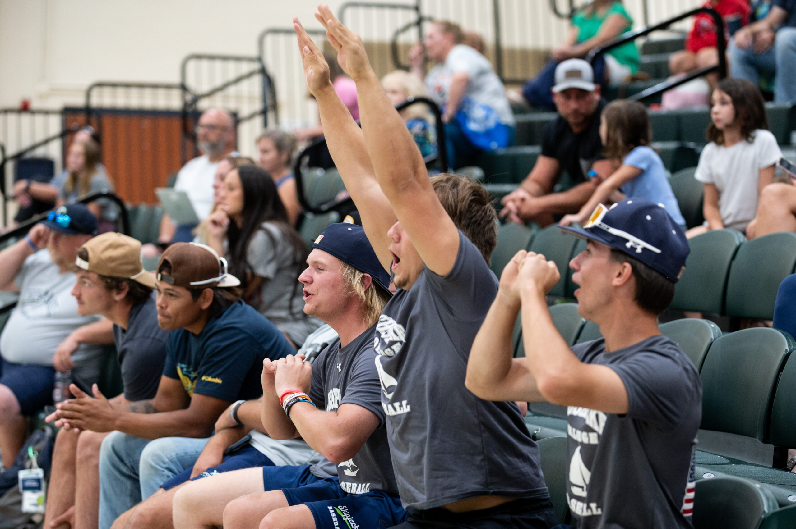 Student athletes cheer for the Skipjack team from the bleachers in the HPAC gym