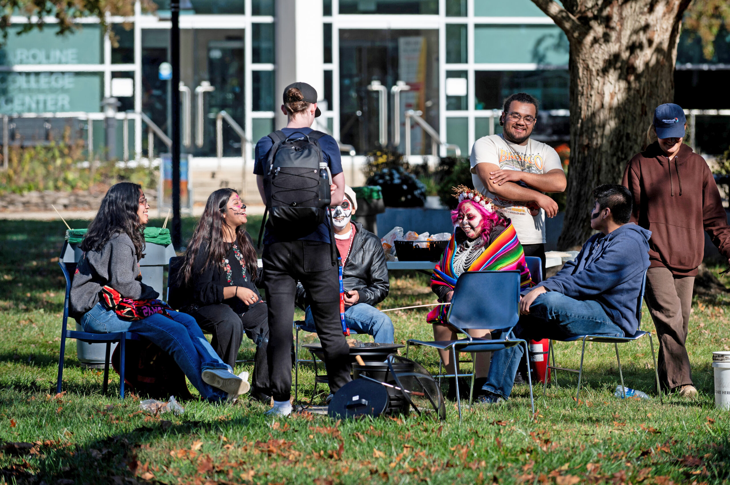 Students gather around the fire pit during Fall Fest