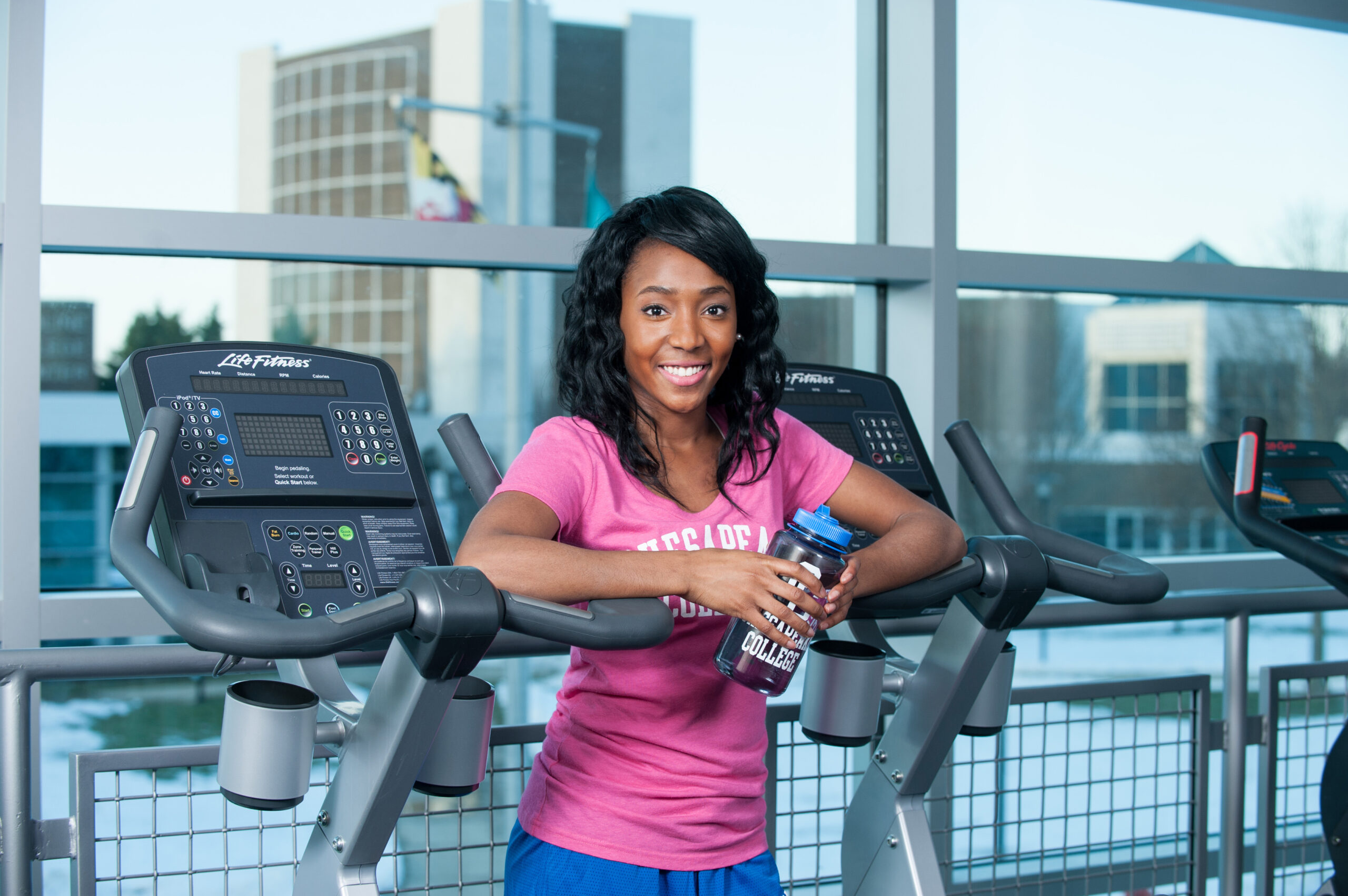 Personal Trainer standing between two treadmills