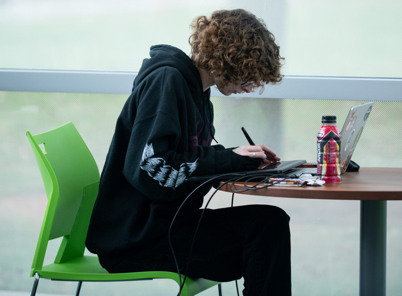 Student researching on laptop in library