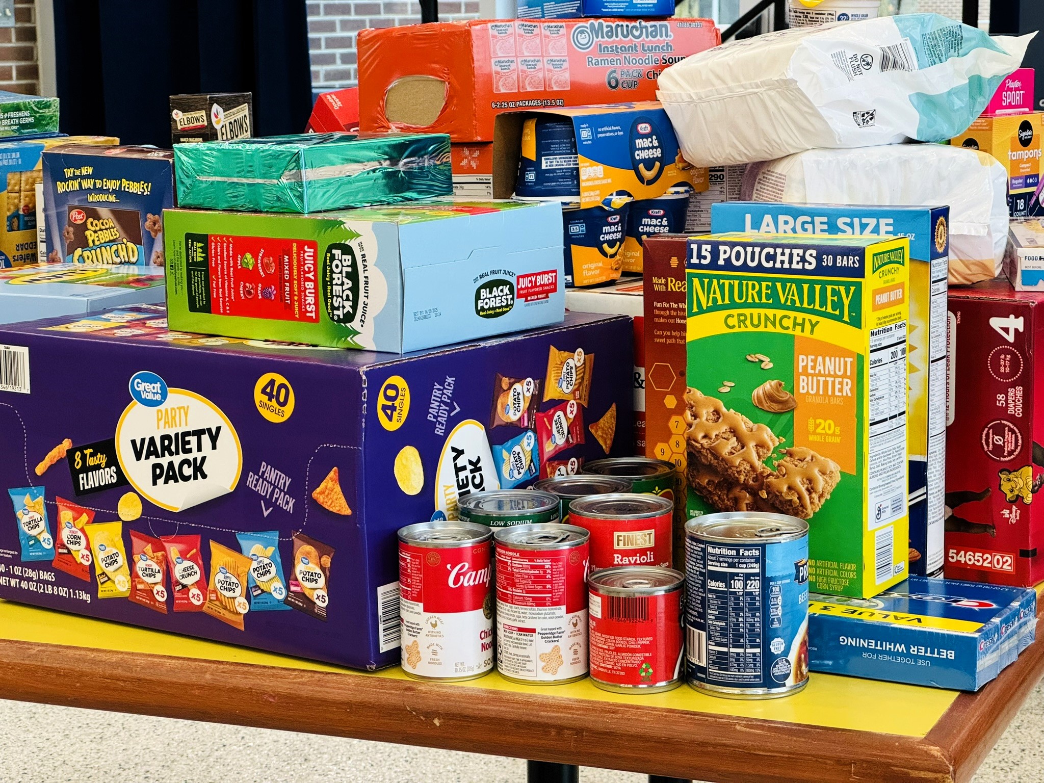 Corner of Care food pantry donation items stacked on a table