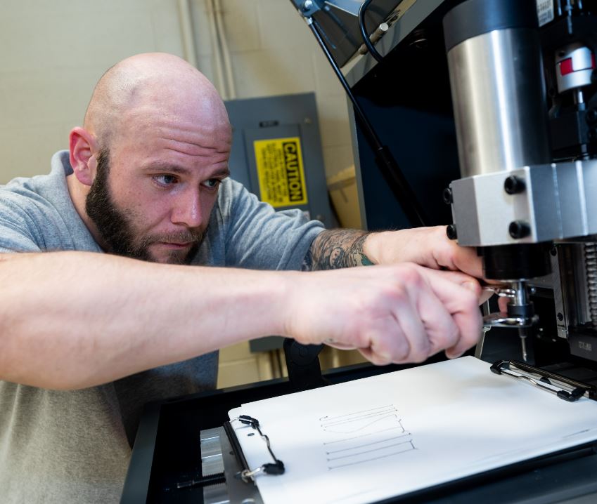 man working on fanuc robot