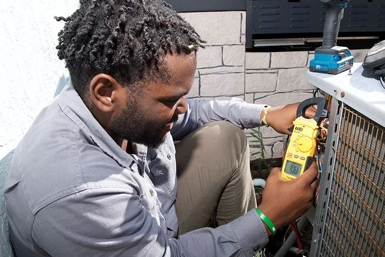 man working on hvac unit outside