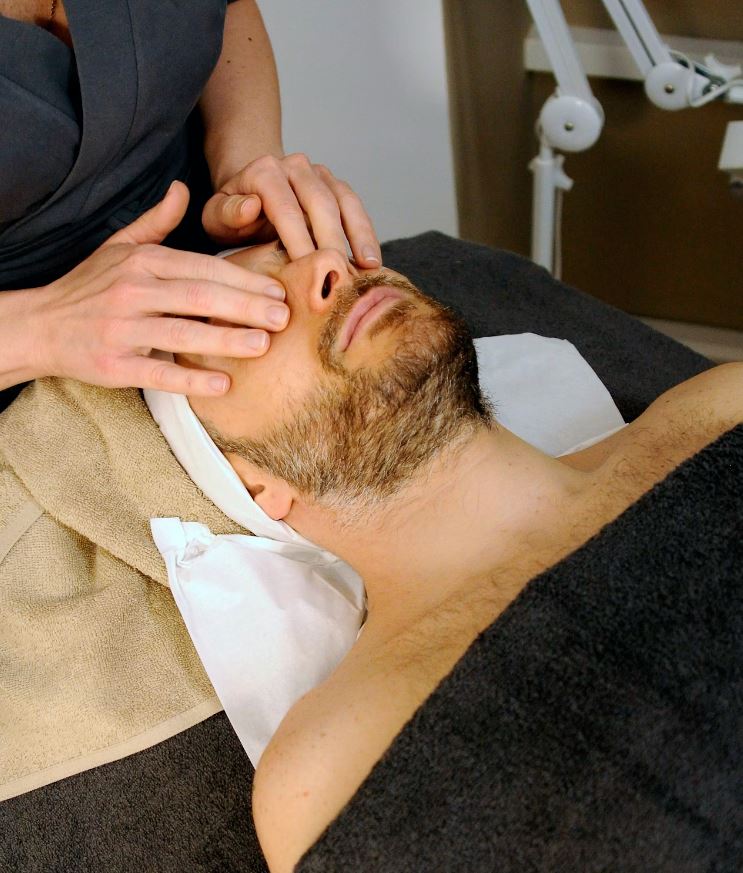 sleeping man while having a massage