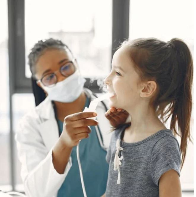 doctor gives patient a nebulizer breathing treatment